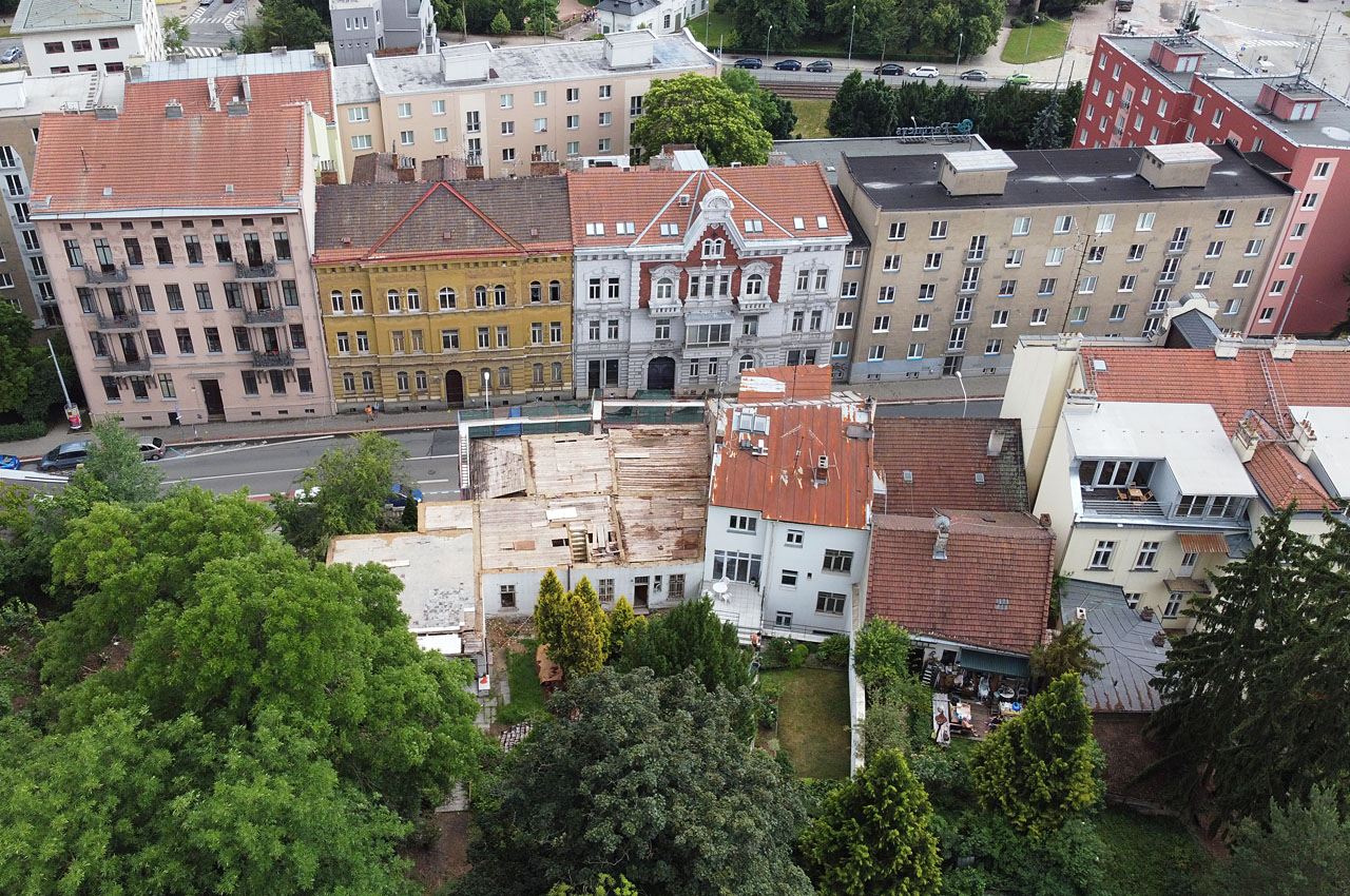 Pohled zpoza dvora na vilu po nelegálním odstranění krovů. Zde se nacházel hliník původní cihelny. Pohled zpoza dvora na vilu po nelegálním odstranění krovů. Zde se nacházel hliník původní cihelny.